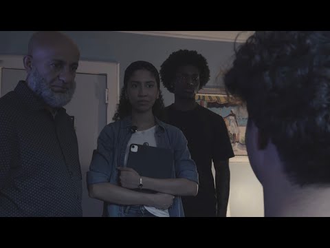 Young filmmakers working with a phone camera and compact light on a city rooftop
